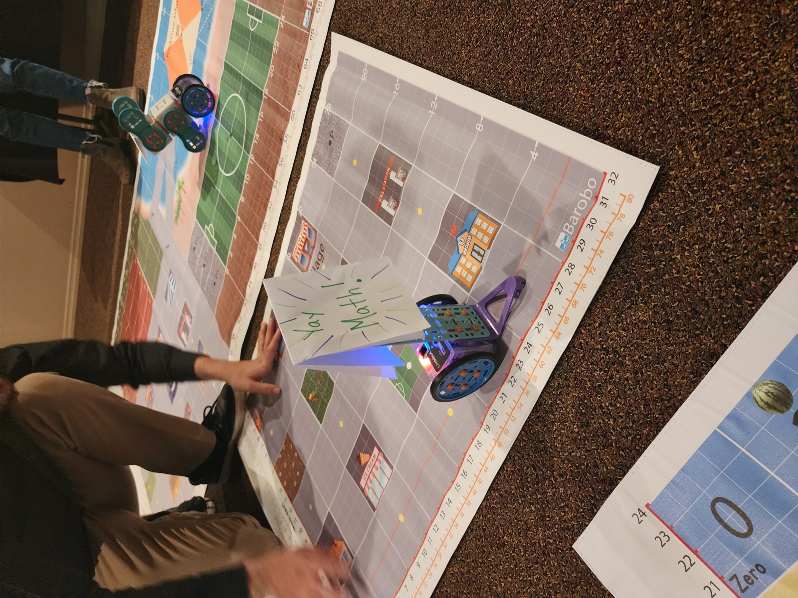 Picture of Barobo village mats with robots and a sign that says "Yay Math!!"